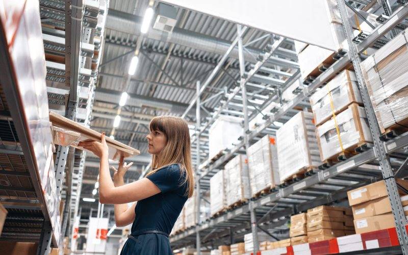 Trabajadora recogiendo productos de las estanterías de un almacén